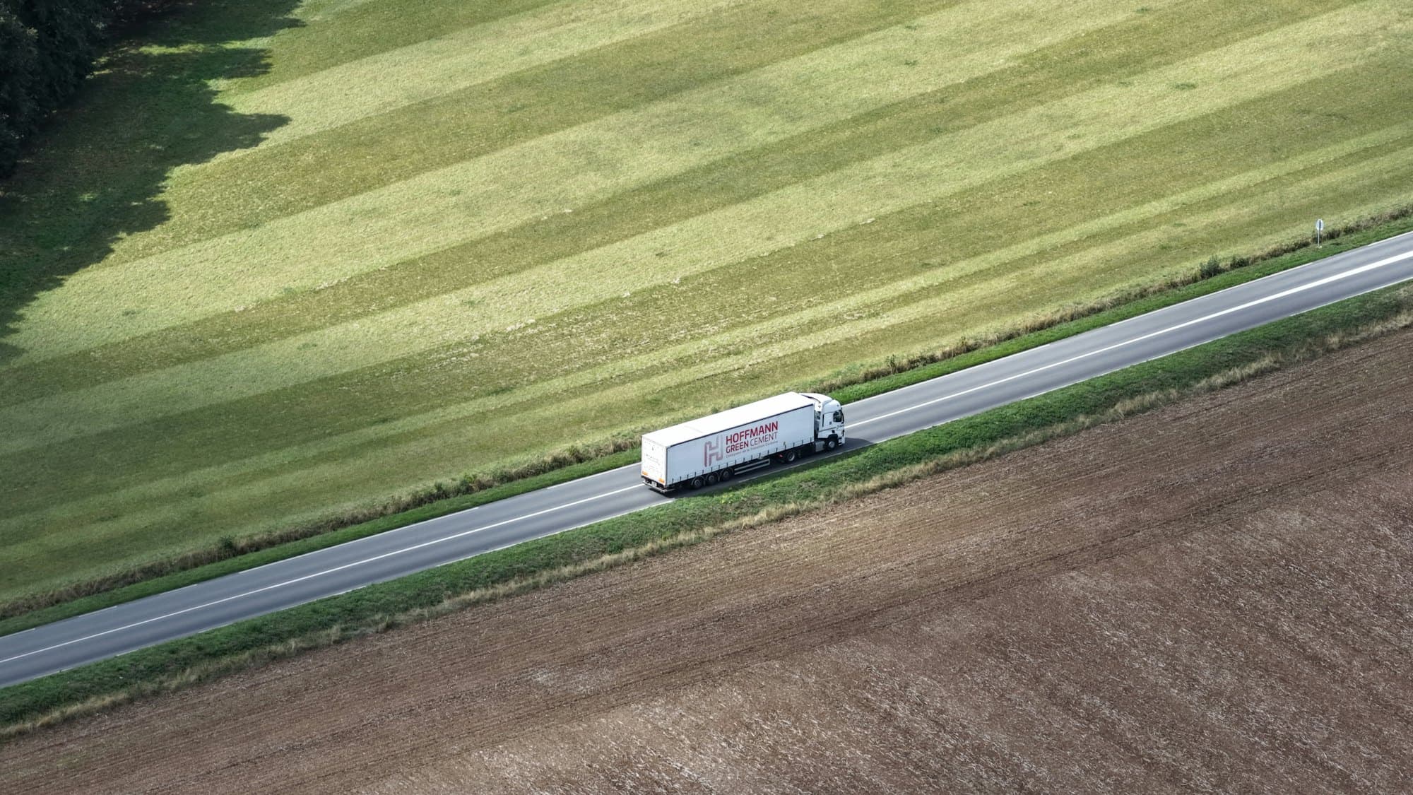 Aerial view of a freight truck on an open road